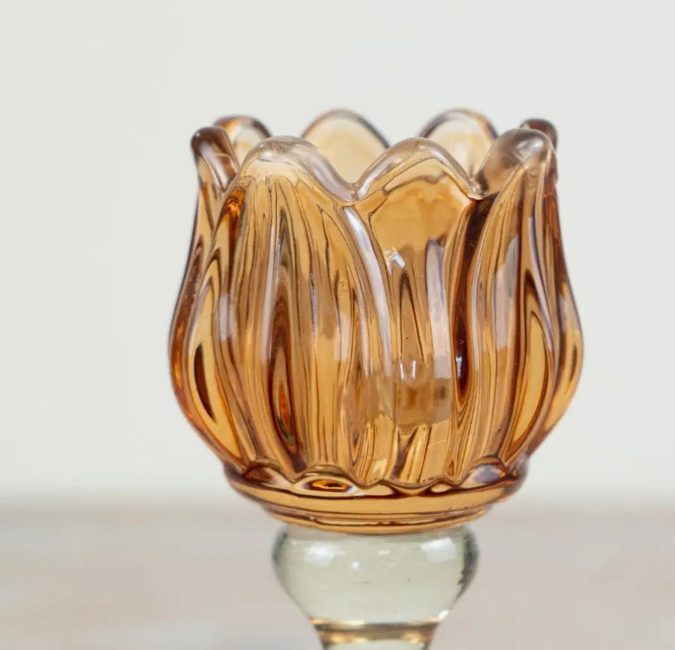 Amber flower glass tealight holder with a fluted design for cosy home décor.