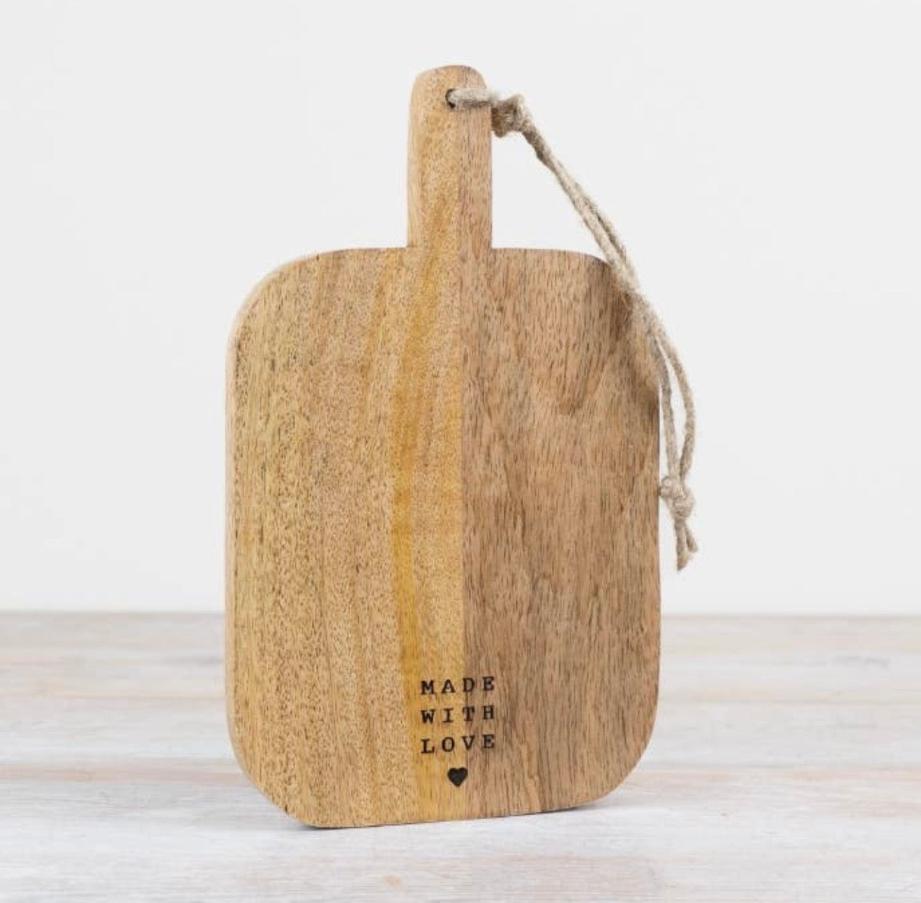 Wooden chopping and serving board with handle for food preparation, serving and kitchen styling.