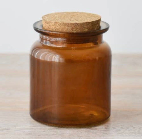 Amber glass storage jar with cork lid.