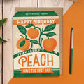 Orange and green Happy Birthday Absolute Peach sentimental seeds greeting card with illustrated peaches, leaves and flowers.
