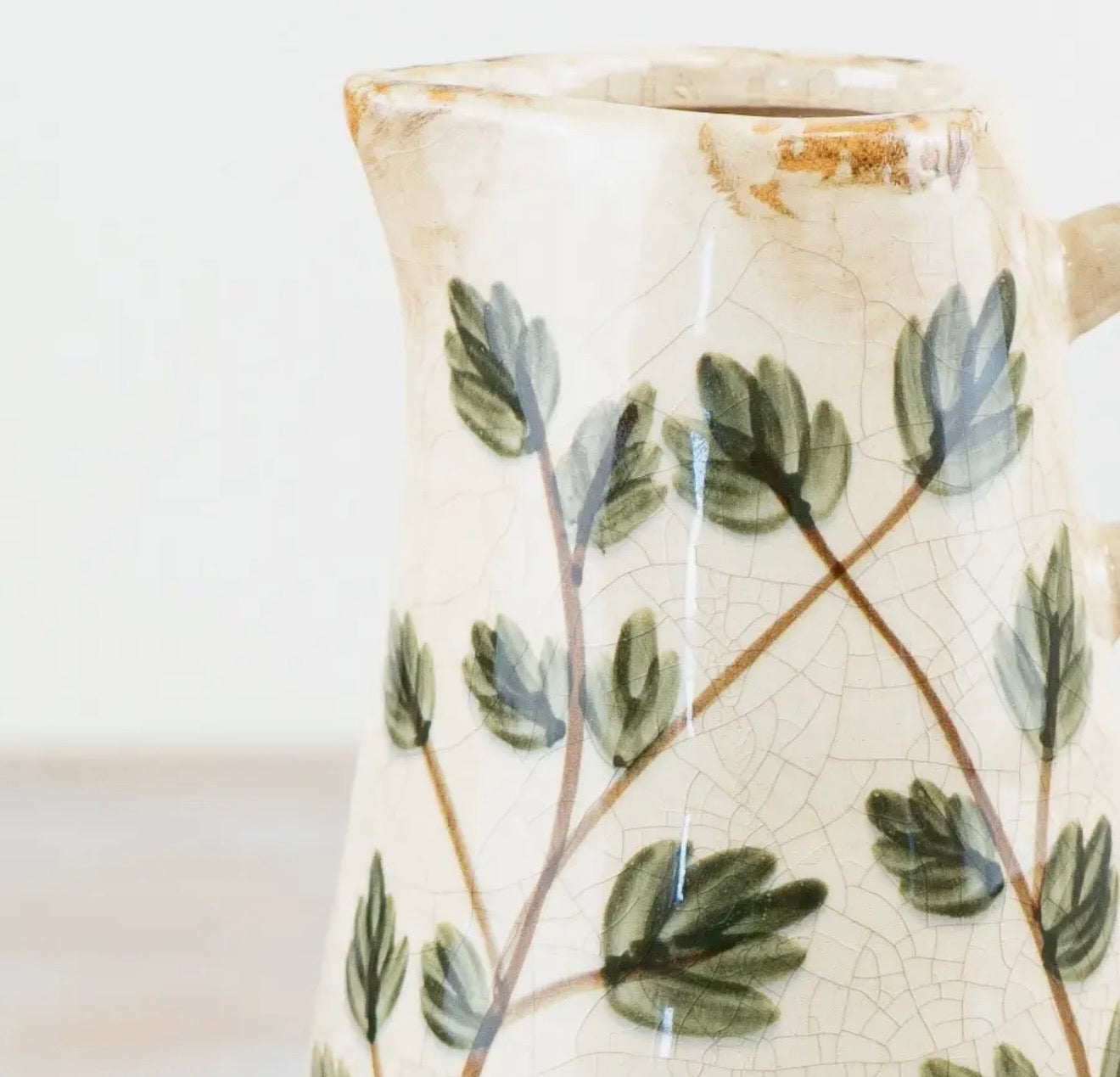 Botanical ceramic vase jug with leaf design for fresh flowers or decorative styling.
