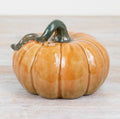 Glossy ceramic pumpkin ornament for autumn home décor and seasonal styling.