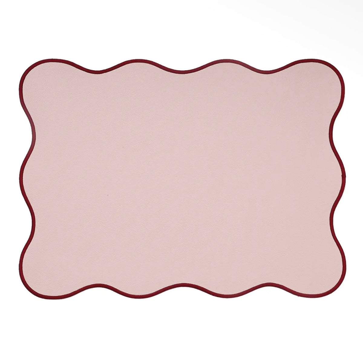 Rectangular blush pink placemat with a wavy scalloped edge and contrasting burgundy border.