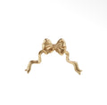 Gold bow wall decoration with sculpted ribbon loops and flowing tails.
