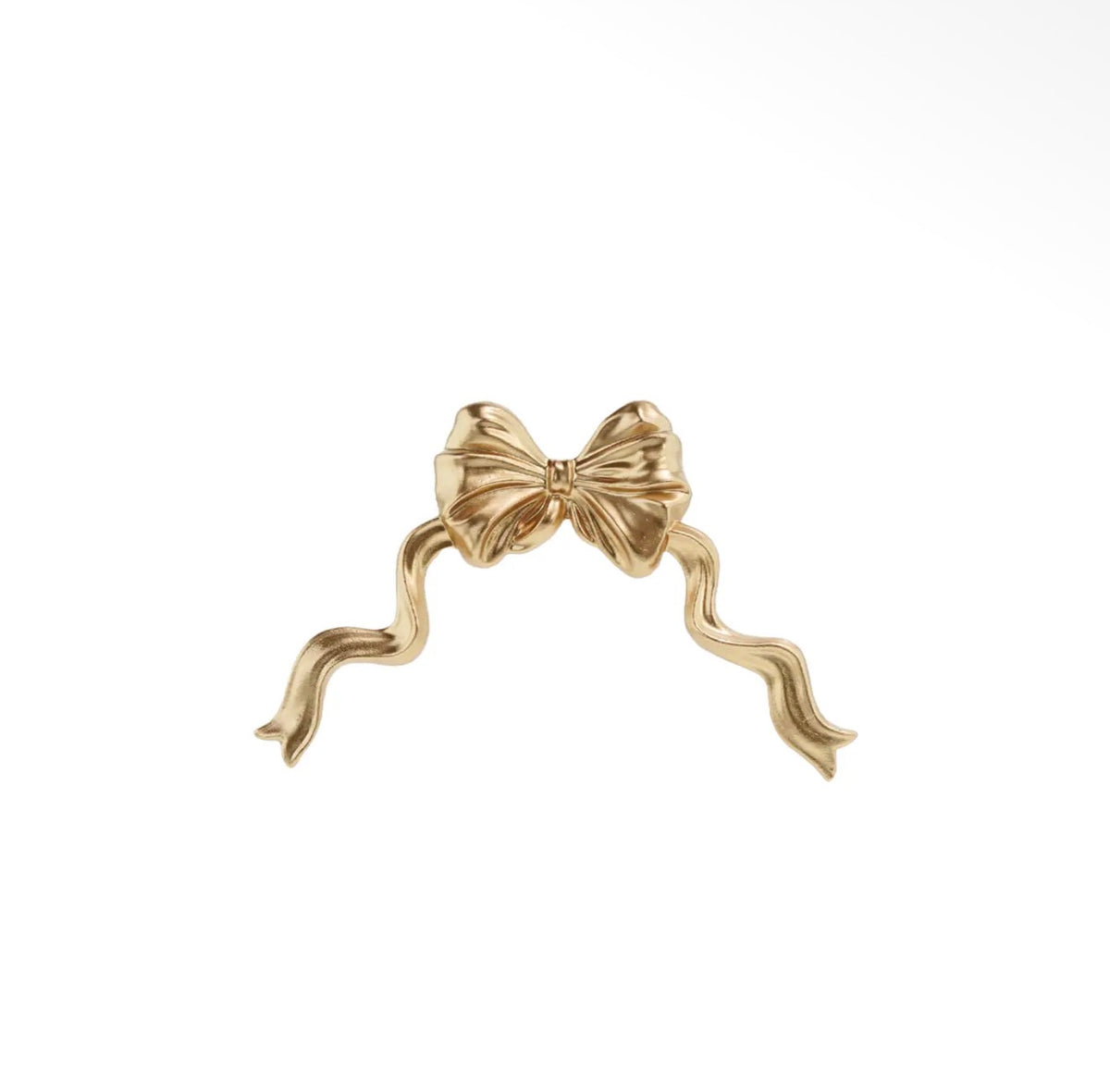 Gold bow wall decoration with sculpted ribbon loops and flowing tails.