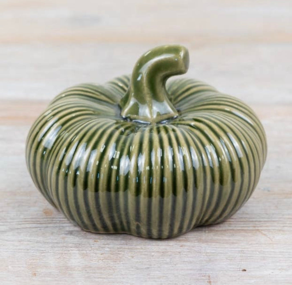 Green ribbed ceramic pumpkin ornament for autumn home décor and seasonal styling.