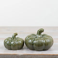 Green ribbed ceramic pumpkin ornament for autumn home décor and seasonal styling.