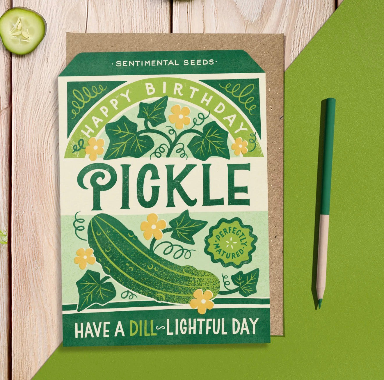 Green Happy Birthday Pickle sentimental seeds greeting card with illustrated pickle, flowers and the words Have a Dill-lightful Day.