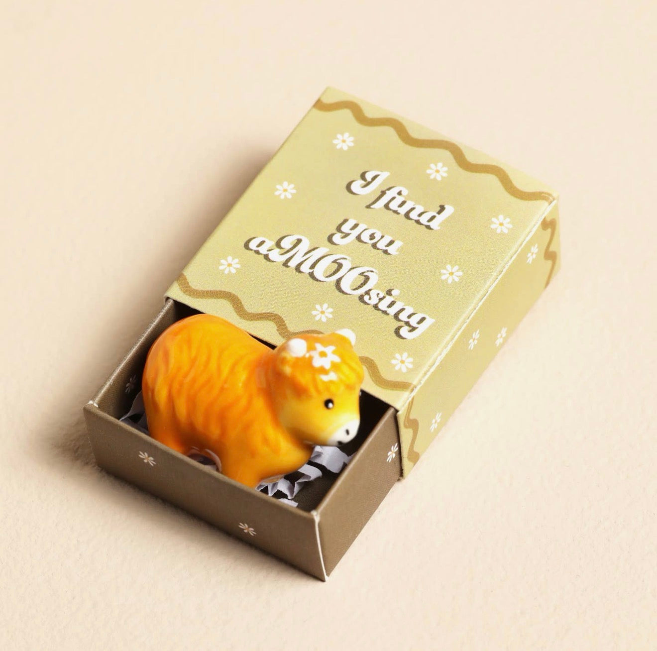 Ceramic Highland cow keepsake token presented in a matchbox with the message “I Find You Amoosing”.