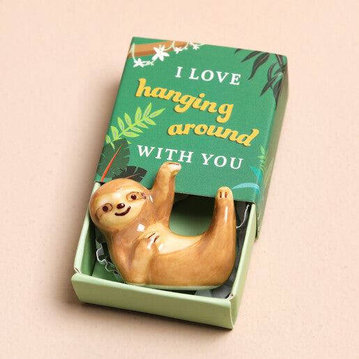 Ceramic sloth keepsake token presented in a green matchbox with the message “I Love Hanging Around With You”.
