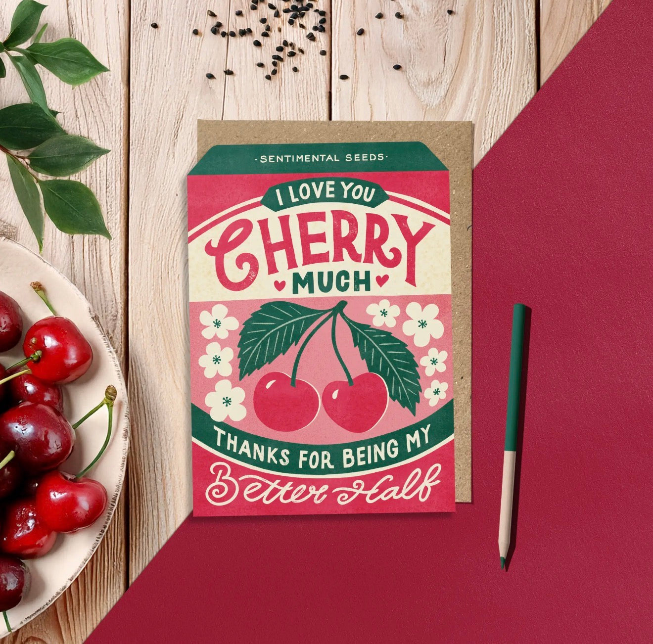 Pink and red I Love You Cherry Much greeting card with illustrated cherries, green leaves and white flowers.