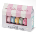 Set of five pastel macaron-shaped erasers in pink, blue, yellow and mint displayed in a patisserie-style box.