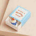 Ceramic birthday cupcake keepsake token presented in a blue matchbox with the message “Make a Birthday Wish”.