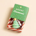 Ceramic Christmas tree keepsake token presented in a green festive matchbox with the message “Merry Christmas”.