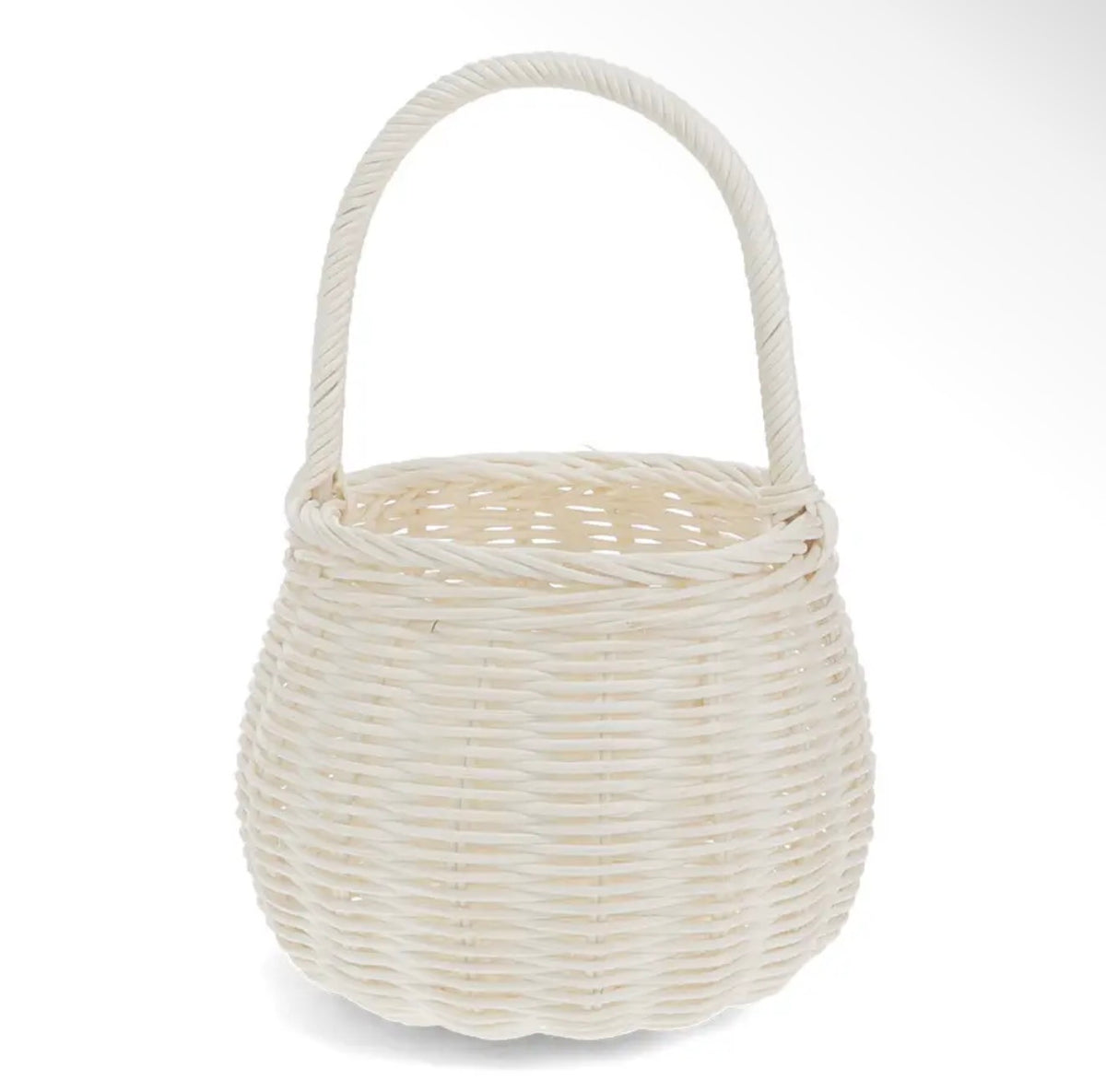 Small natural woven wicker basket with a rounded shape and tall curved carry handle.