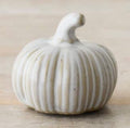 Neutral ribbed ceramic pumpkin ornament with a soft matte finish for autumn home décor and seasonal styling.