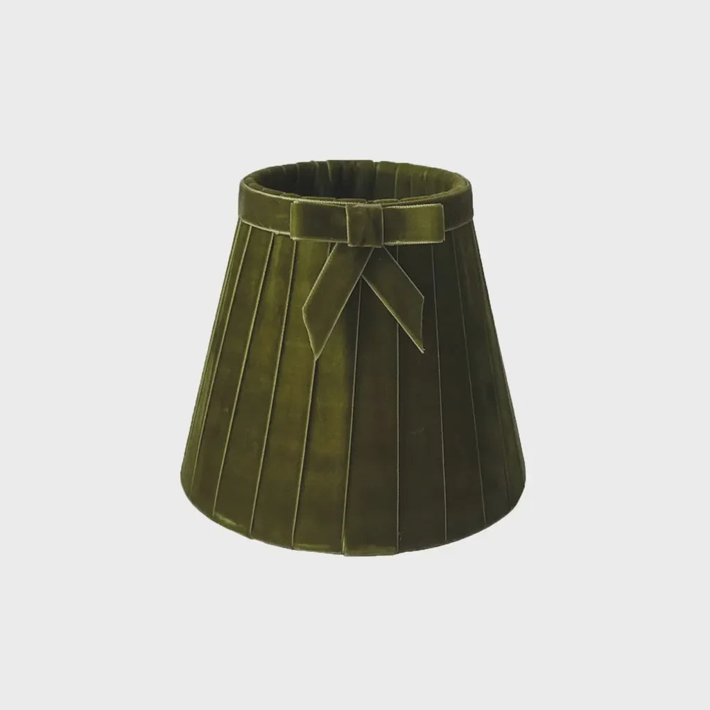 Olive green velvet pleated lampshade with a decorative matching bow around the top edge.