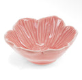 Small glossy pink ceramic bowl shaped like an open flower with sculpted petal detailing.
