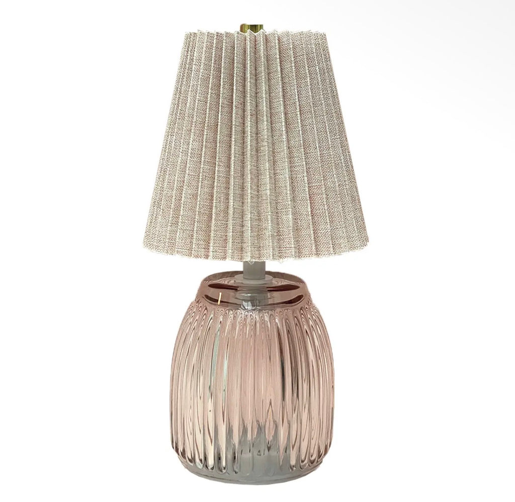 Pink ribbed battery operated LED table lamp with a neutral pleated fabric shade.