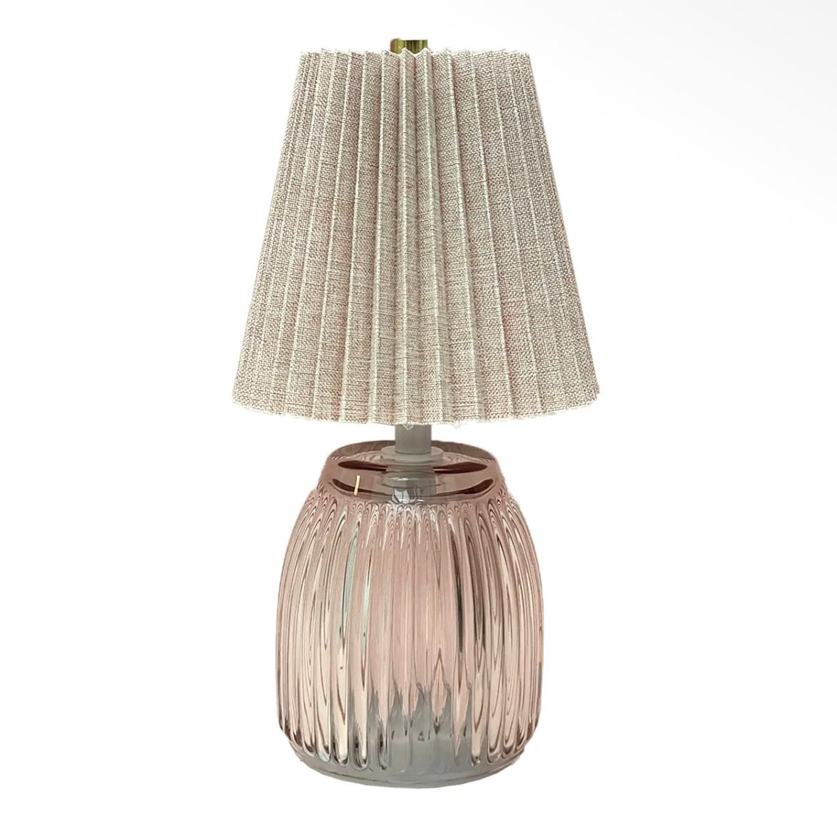 Pink ribbed battery operated LED table lamp with a neutral pleated fabric shade.