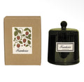Raspberry scented candle in a dark green glass bell jar with lid, presented beside its botanical gift box.