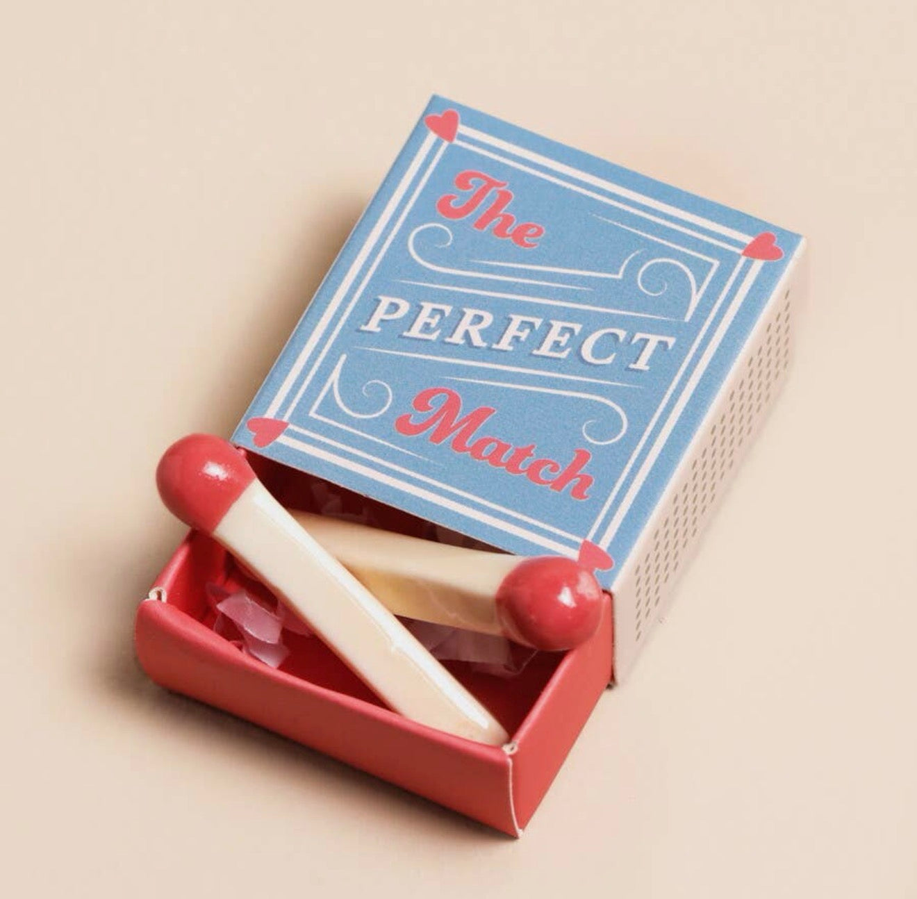 Pair of ceramic match keepsake tokens presented in a blue and red matchbox with the message “The Perfect Match”.