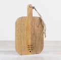 Wooden chopping and serving board with handle for food preparation, serving and kitchen styling.