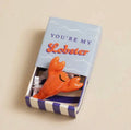 Ceramic lobster keepsake token presented in a colourful matchbox with the message “You’re My Lobster”.