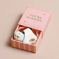 Ceramic dog keepsake token presented in a pink matchbox with the message “You’re Pawfect”.